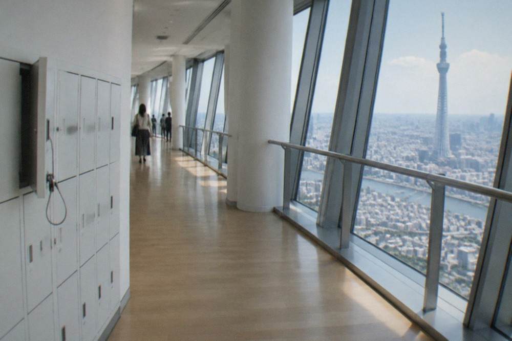Empty free lockers in a row along a bright museum corridor wall