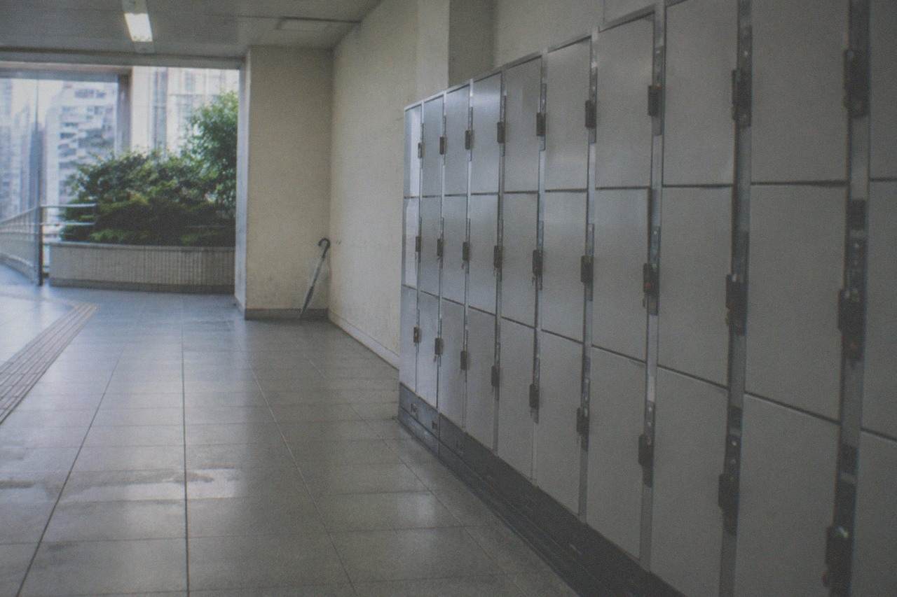 Rows of grey coin lockers along a quiet station corridor in Tokyo