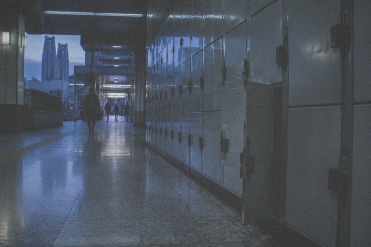 A row of silver coin lockers along a quiet station corridor in Tokyo